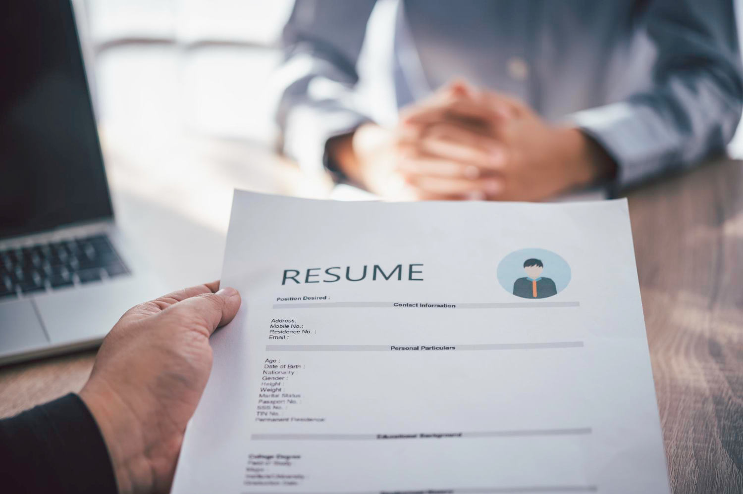 Person holding a resume during an interview